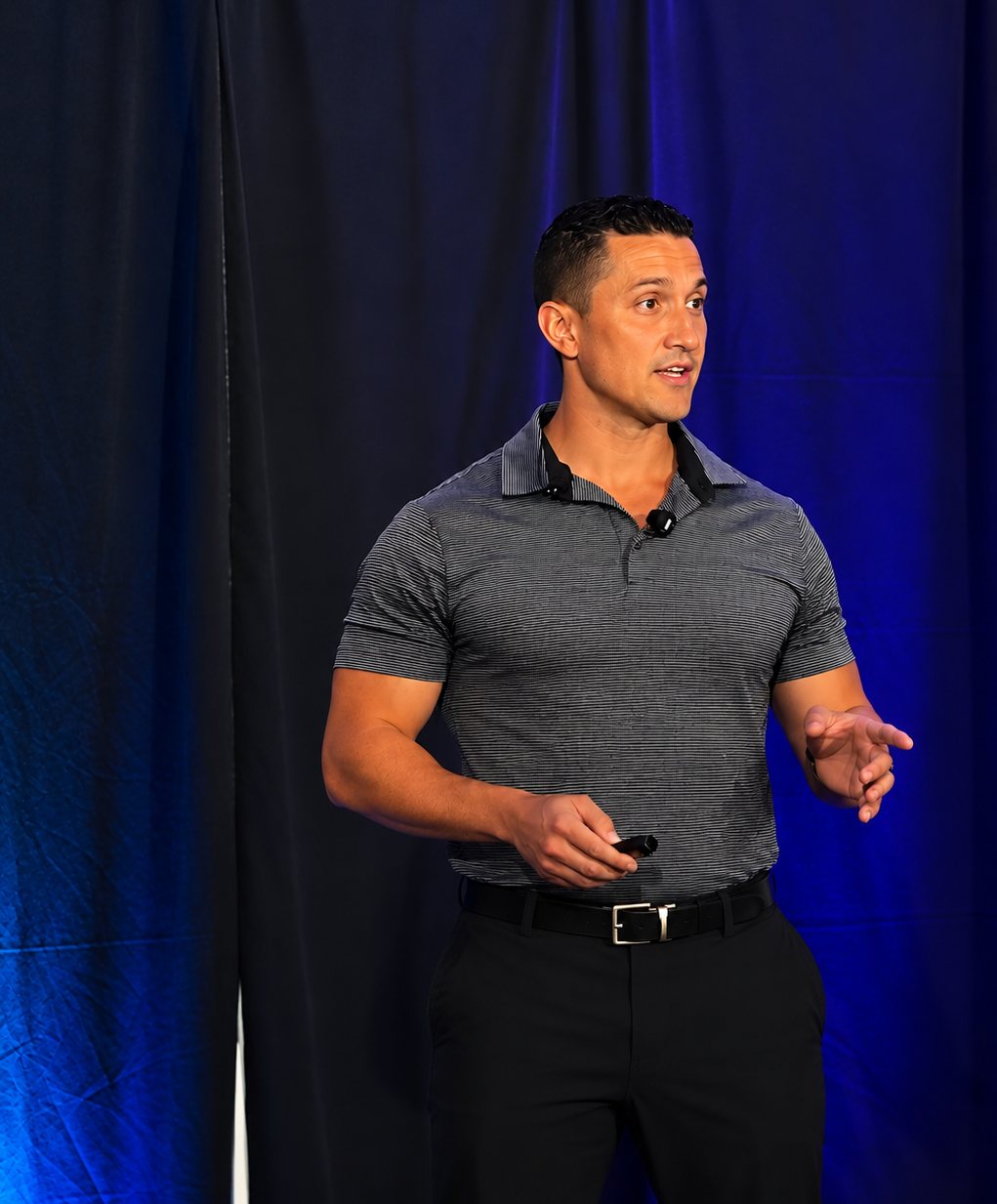 Tom Leonardis speaking on stage at a fitness business event